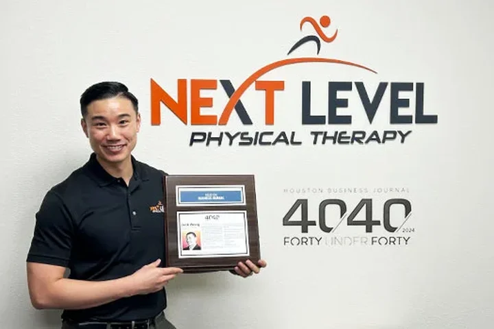 Dr. Jack Wong with his Houston Business Journal 40 Under 40 award inside the Kingwood clinic
