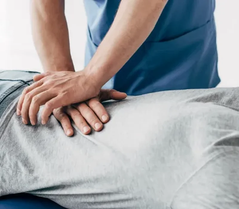 Clinician performing hands-on manual therapy and joint mobilization