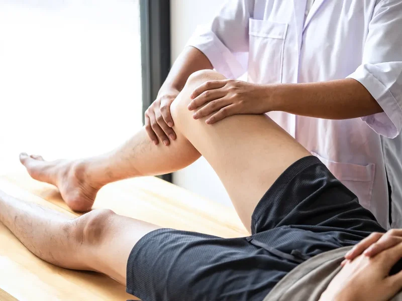 Doctor of Physical Therapy guiding a patient through a movement evaluation