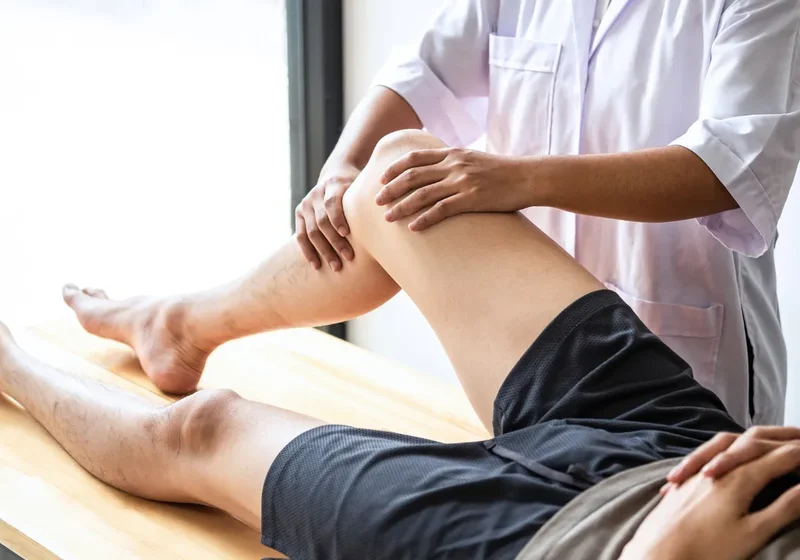 Physical therapist guiding a patient through a hands-on treatment session