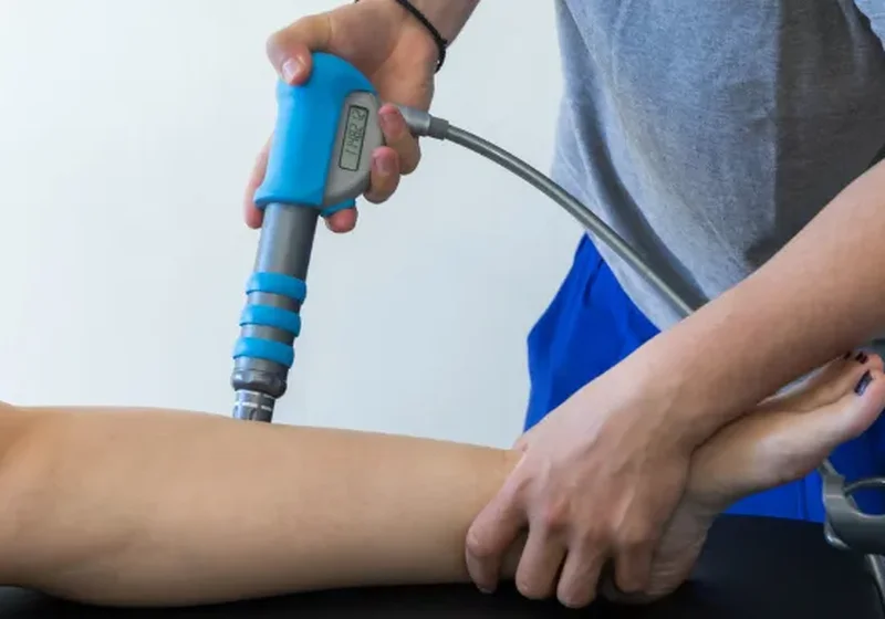 Shockwave therapy device being used on a patient's tendon